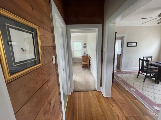 hall with wood finished floors and baseboards