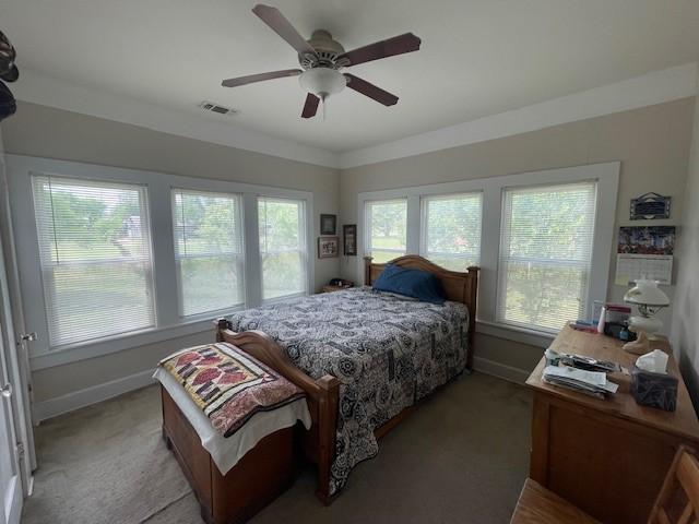 bedroom with light carpet, baseboards, and ceiling fan