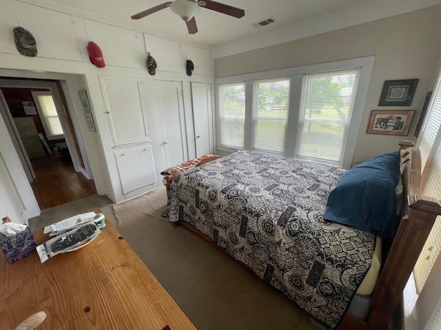 carpeted bedroom with ceiling fan
