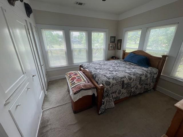 bedroom featuring light carpet and baseboards