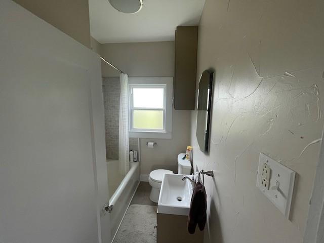 full bath featuring toilet, vanity, and bathing tub / shower combination