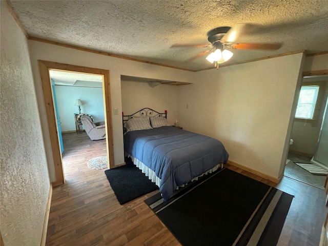 bedroom with a textured wall, wood finished floors, a textured ceiling, crown molding, and ceiling fan