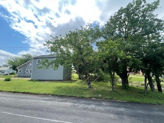 view of side of home featuring a lawn