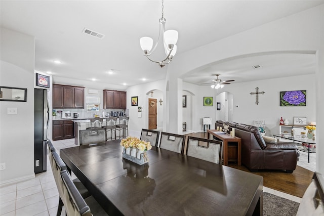 239 Springwood Ranch Loop, Springtown, TX 76082 - dining area featuring arched walkways, ceiling fan, a chandelier, recessed lighting, and light tile patterned flooring