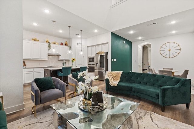 1124 Queensdown Way, Forney, TX 75126 - living area featuring light wood-style floors, arched walkways, recessed lighting, and baseboards