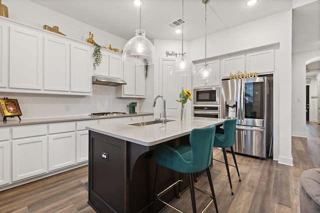 1124 Queensdown Way, Forney, TX 75126 - kitchen with appliances with stainless steel finishes, decorative backsplash, arched walkways, recessed lighting, and white cabinetry