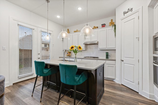 1124 Queensdown Way, Forney, TX 75126 - kitchen with a sink, decorative backsplash, an island with sink, light countertops, and dark wood-style floors