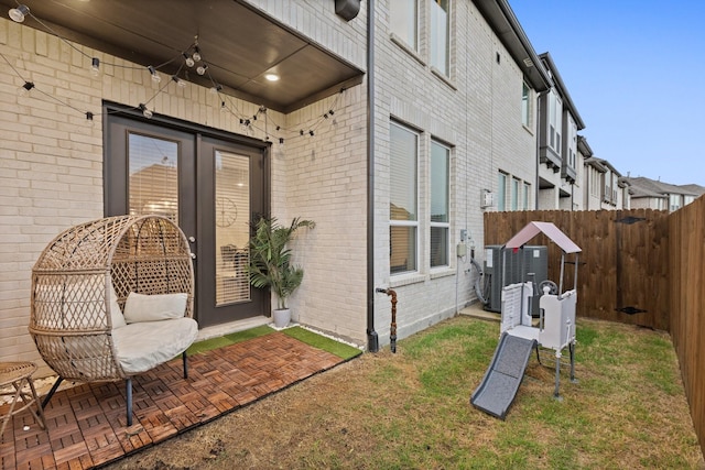 1124 Queensdown Way, Forney, TX 75126 - view of side of home featuring brick siding, central AC, and french doors