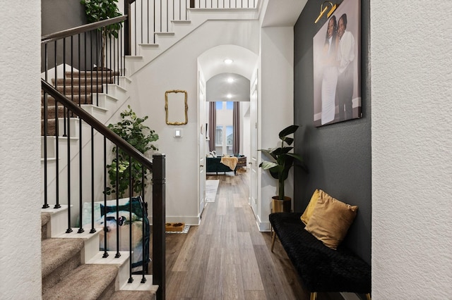 1124 Queensdown Way, Forney, TX 75126 - foyer entrance featuring wood finished floors, arched walkways, stairway, a textured wall, and baseboards