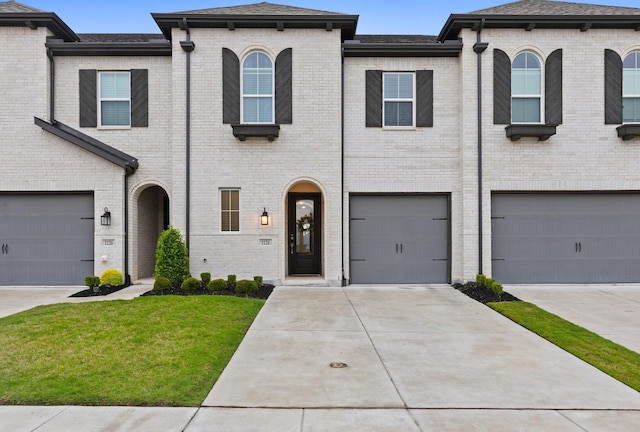 1124 Queensdown Way, Forney, TX 75126 - view of front facade with brick siding, a front yard, a shingled roof, driveway, and a garage