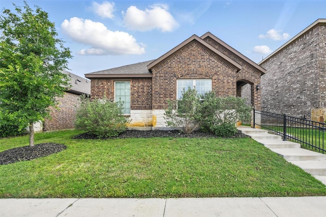 view of front of house with brick siding and a shingled roof