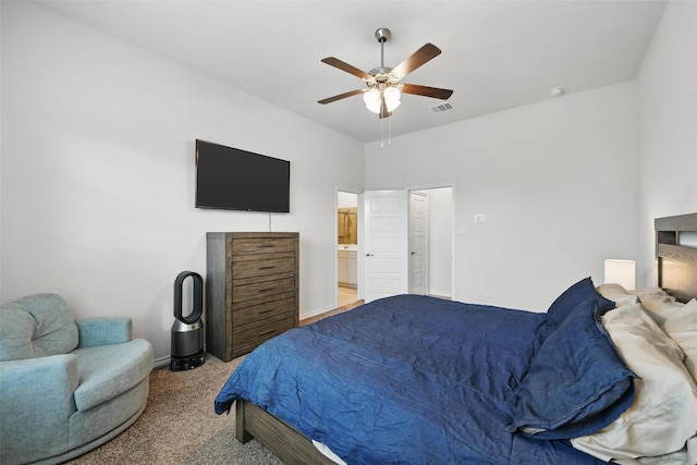 bedroom with carpet flooring, a ceiling fan, baseboards, and ensuite bathroom
