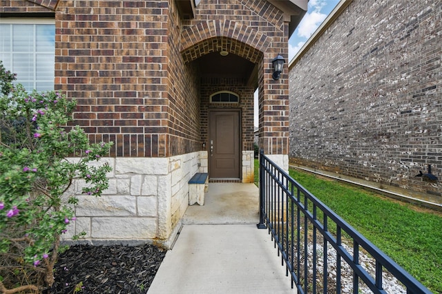 property entrance featuring brick siding