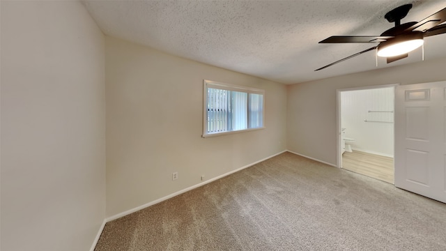 5828 Cynthia Cir, North Richland Hills, TX 76117 - unfurnished bedroom with carpet floors, a textured ceiling, baseboards, ensuite bath, and a ceiling fan