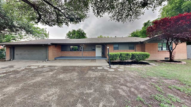 5828 Cynthia Cir, North Richland Hills, TX 76117 - ranch-style house featuring a garage, brick siding, and driveway