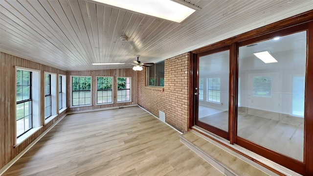 5828 Cynthia Cir, North Richland Hills, TX 76117 - unfurnished sunroom with brick wall, wood finished floors, and wooden ceiling