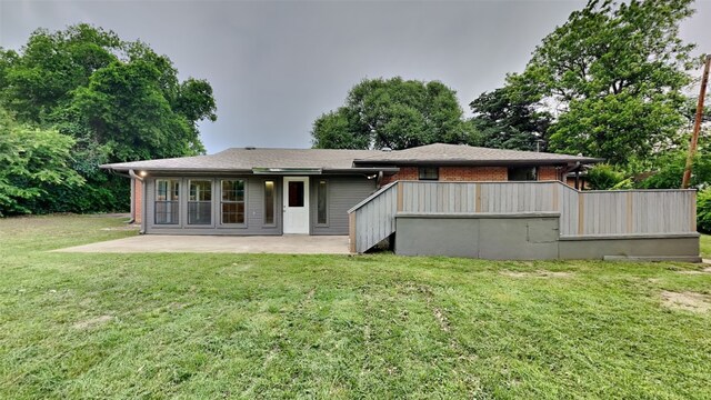 5828 Cynthia Cir, North Richland Hills, TX 76117 - back of house featuring a patio area, a lawn, and brick siding