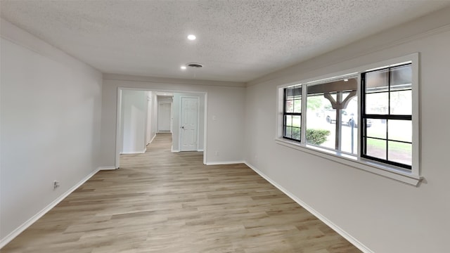 5828 Cynthia Cir, North Richland Hills, TX 76117 - spare room with a textured ceiling, light wood-style flooring, recessed lighting, and baseboards
