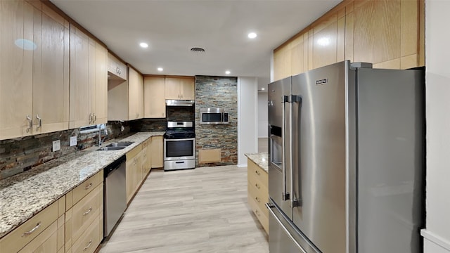 5828 Cynthia Cir, North Richland Hills, TX 76117 - kitchen with appliances with stainless steel finishes, a sink, backsplash, light wood-style flooring, and light stone countertops