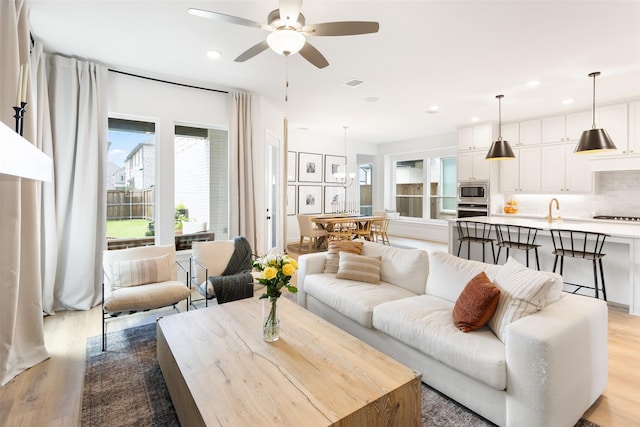 3545 W Cheney Ave, Celina, TX 75009 - living room with light wood-type flooring, a ceiling fan, and recessed lighting