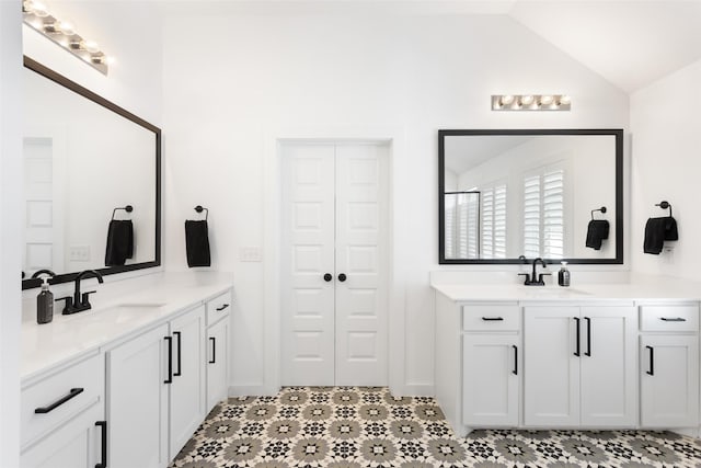 3545 W Cheney Ave, Celina, TX 75009 - bathroom featuring two vanities, vaulted ceiling, and tile patterned floors
