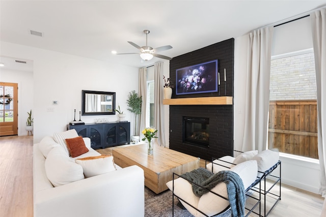 3545 W Cheney Ave, Celina, TX 75009 - living room featuring a brick fireplace, wood finished floors, ceiling fan, recessed lighting, and baseboards