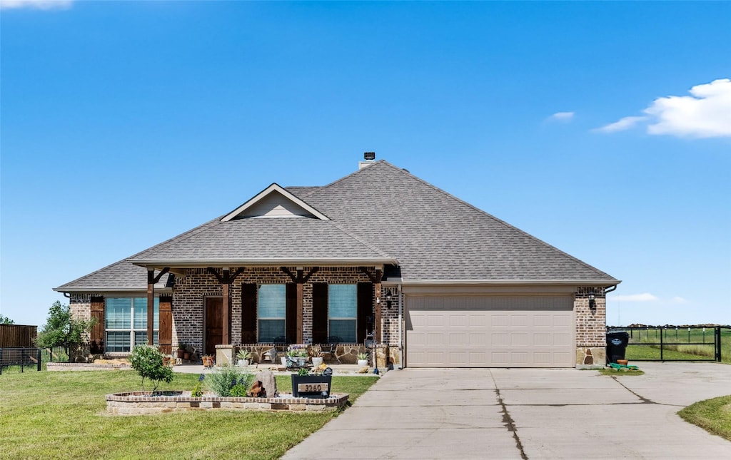 3260 Florance Rd, Ponder, TX 76259 - view of front facade with brick siding, a garage, driveway, and roof with shingles