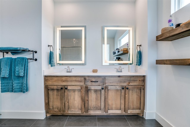full bathroom with baseboards, tile patterned flooring, and double vanity