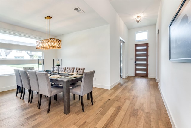 dining area featuring light wood-style flooring and baseboards