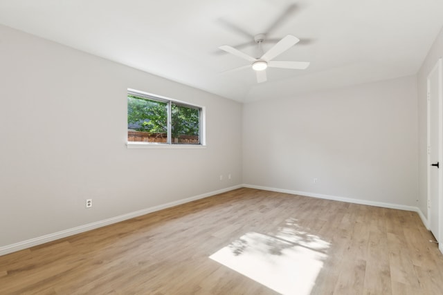 empty room featuring light wood-style floors, baseboards, and ceiling fan