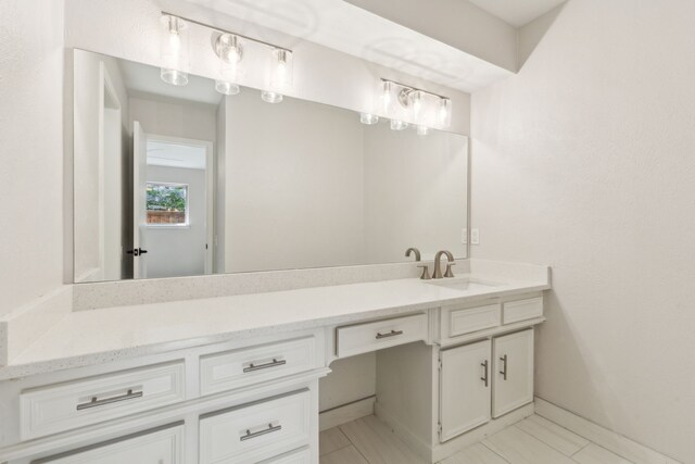 bathroom featuring vanity and baseboards