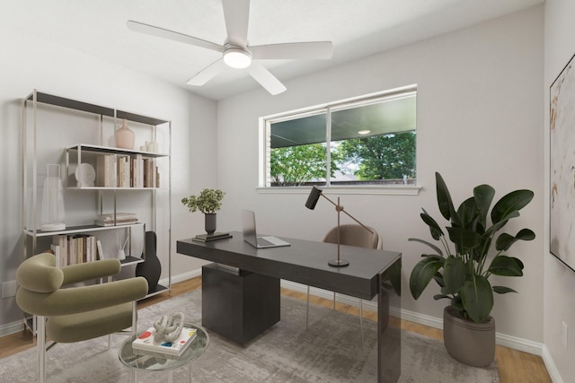 office space featuring wood finished floors, a ceiling fan, and baseboards