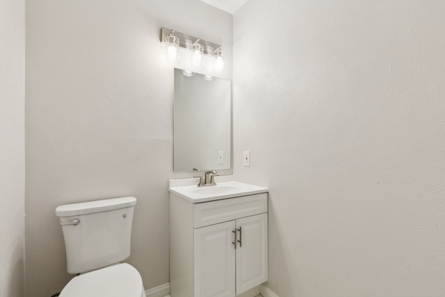 bathroom featuring toilet and vanity
