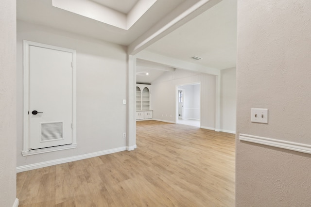 unfurnished room featuring light wood-style floors and baseboards