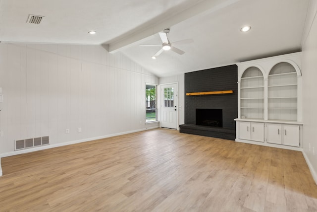 unfurnished living room featuring ceiling fan, light wood-style flooring, and a brick fireplace