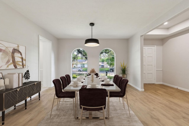 dining area featuring light wood-style flooring, baseboards, and recessed lighting