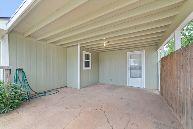 view of patio with fence and a carport