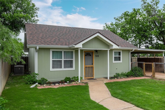 view of front of home featuring a shingled roof and central AC
