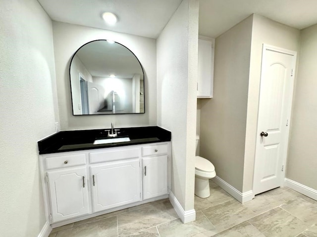 5711 Trail Lake Dr, Arlington, TX 76016 - bathroom with toilet, baseboards, and vanity
