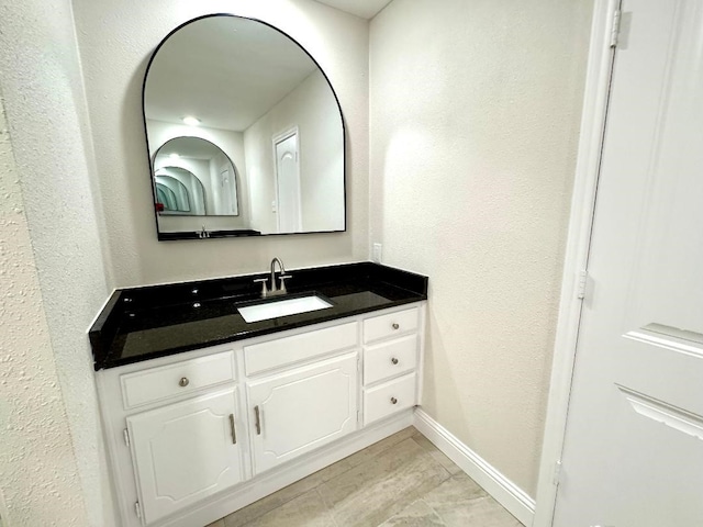 5711 Trail Lake Dr, Arlington, TX 76016 - bathroom featuring vanity, baseboards, and a textured wall