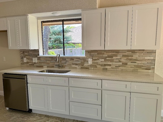 5711 Trail Lake Dr, Arlington, TX 76016 - kitchen featuring dishwasher, a sink, and white cabinets