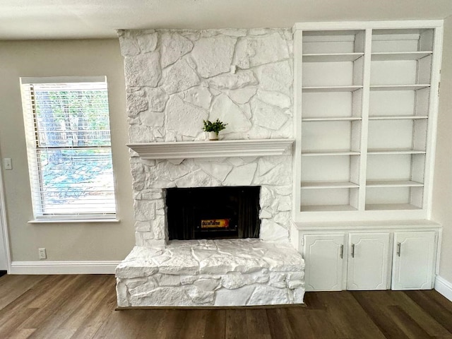 5711 Trail Lake Dr, Arlington, TX 76016 - detailed view of baseboards, wood finished floors, and a stone fireplace