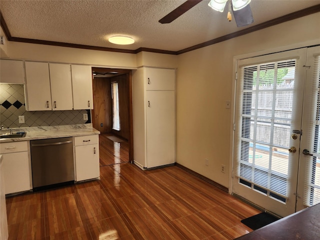2612 Santa Barbara Dr, Grand Prairie, TX 75052 - kitchen with stainless steel dishwasher, light countertops, crown molding, a ceiling fan, and white cabinets