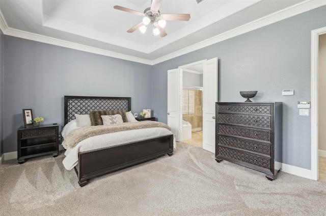 5063 Stillwater Trl, Frisco, TX 75034 - carpeted bedroom featuring a tray ceiling, ornamental molding, baseboards, ensuite bathroom, and ceiling fan