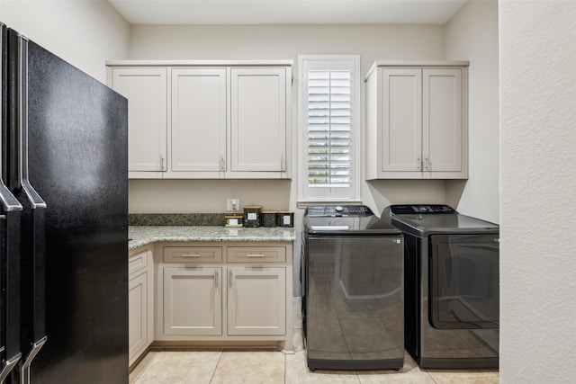 5063 Stillwater Trl, Frisco, TX 75034 - laundry room with cabinet space, washer and clothes dryer, and light tile patterned floors