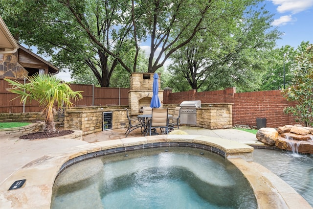 5063 Stillwater Trl, Frisco, TX 75034 - view of swimming pool featuring a fireplace, exterior kitchen, a fenced backyard, a patio area, and grilling area