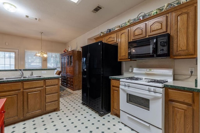 600 Hanover Dr, Waxahachie, TX 75165 - kitchen featuring black appliances, brown cabinets, light floors, and dark countertops