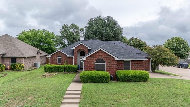600 Hanover Dr, Waxahachie, TX 75165 - view of front of property with brick siding, a front lawn, a chimney, and a shingled roof