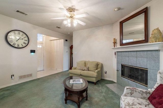 600 Hanover Dr, Waxahachie, TX 75165 - living room featuring carpet, a ceiling fan, and a tiled fireplace