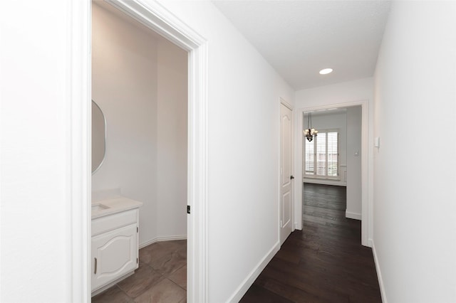7100 Oakbrook Dr, Plano, TX 75025 - hall featuring baseboards, recessed lighting, wood finished floors, and a chandelier